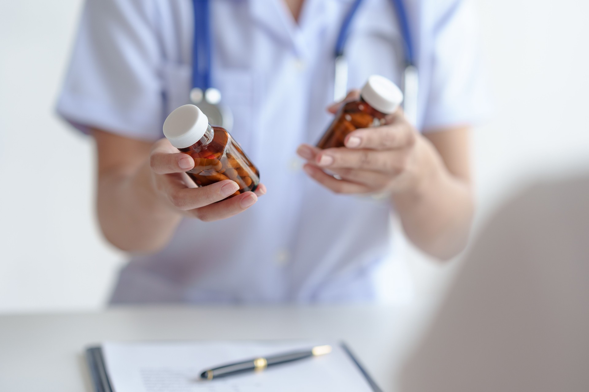 Doctor is explaining to the patient information about the use of the drug, the indication, how to take it side effect of the drug and the patient's medication history record.