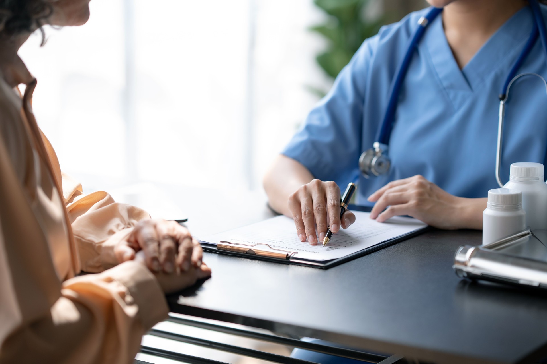 Female doctor is treating a patient and dispensing medicine.